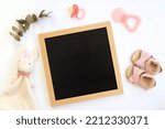 Blank pregnancy girl baby announcement mockup flat lay with blank letter board pacifier, toy and shoes