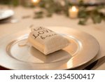 Small photo of Canvass bag that reads "let Love Brew" wedding center piece filled with cofee grinds on dinner table