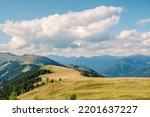 Alpine summer landscape in the Nock Mountains national park, the national park is characterized by peaceful hilly mountains covered with grassy meadows, Gurktal Alps, Austria.