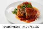 Small photo of Stuffed cabbage rolls with tomato sauce and herbs