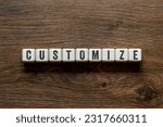 Small photo of Customize - word concept on building blocks, text, letters