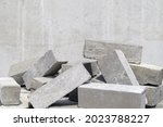 A pile of cement type bricks. Solid brick is used for construction. Lots of loose concrete bricks at the construction site