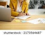 Woman planning working schedule writing in notebook at office close up. Work from home concept