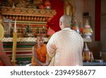 Small photo of backyard asian man in Buddhism matriculate ceremony to be monk in Thai temple. Tradition ceremony in buddha religion concept