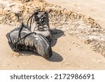 abandoned old shoes on the sand