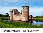 Triangular shaped castle with water filled moat originally built in 13th century.