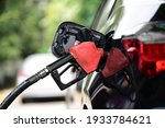 Refueling Car fill with petrol gasoline at  gas station and Petrol pump filling fuel nozzle in fuel tank of car