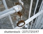                             Prison Handcuffs hang on Jail 