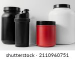 containers of weight gainers, protein and creatine on a white isolated background