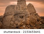 Small photo of The ancient carved heads of Zeus, Apollo, Hercules and lion at sunset on the east terrace at Mount Nemrut (Nemrut Dagi) an archaeological site of the ancient Kingdom of Commagene in south east Turkey