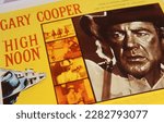 Small photo of Viersen, Germany - March 9. 2023: Closeup of film poster of hollywood western movie High Noon with Gary Cooper from 1952 (focus on center)