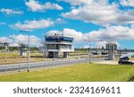 Small photo of Sambeek, Netherlands - June 9. 2023: Dutch modern lockkeeper house at inland river maas sluice complex