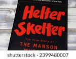 Small photo of Viersen, Germany - May 9. 2023: True crime book cover bestseller Helter Skelter about story of Manson murders (focus on center)