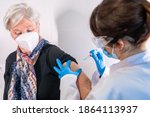 Small photo of An elderly woman receiving the injection of the coronavirus vaccine by a doctor to receive the antibodies, immunize the population. side effects, risk people, antibodies, new normal, covid-19.