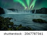 Godafoss waterfall on a night with a beautiful Northern Lights. Iceland