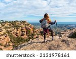 Small photo of A young hiker girl at the top of the El Garbi mountain, the spectacular viewpoint of the Sierra Calderona, Valencia, a 593-meter mountain. Mediterranean Sea. Spain
