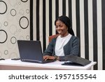 pretty african lady feeling happy as she works in the office