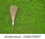 A broomstick on green grass.