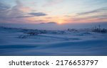 Small photo of Winter arctic landscape. Sunset in the tundra. Early winter twilight. Cold frosty winter weather. Electric poles and satellite dishes in the snowy tundra. Chukotka, Siberia, Far East of Russia, Arctic