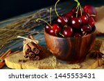Small photo of Rustic Composition of Cherries in wooden bowl on blocks of wood and crat paper. ingedient for cherry desert. Summer dieting.