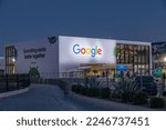 Small photo of Las Vegas, NV 1-6-2023: Google CES booth at CES2023. Cute Android mascot character "Droid" peeks out from walls. Business logo lit up along with Google's slogan, "Everything works better together."