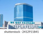 Small photo of Las Vegas, NV 1-14-2024: Fontainebleau building exterior. The mega hotel's fb logo on wall. Seen from street level in front of "We Got Pastrami" restaurant on Convention Center Drive.