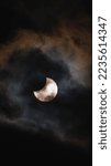 Small photo of 2022 Solar Eclipse behind some clouds with some sun spots being visible without any special filters