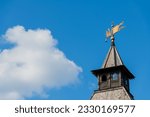 Small photo of Old Tula Kremlin tower with wooden roof and weathercock in a sunny summer day. Clear blue sky with white cloud. Medieval architecture. Copy space for your text. Travel in Russia theme.