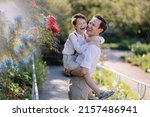 father and son in white shirts walk in park together. Parenthood and childhood. Happy fatherhood. Father's day holiday. Family trust and support. open sincere smile. OurMindsMatter. adhd hyperactivity