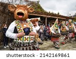 Small photo of Kosharitsa, Bulgaria - March 6, 2022. Bulgarian folk traditions. Carnival show of Kukers. People dressed in scary masks, bells and carnival costumes perform a ritual to ward off the forces of winter.