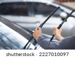 Small photo of Technician replacing windshield wipers change car wiper blades