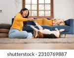Small photo of Asian young woman with beagle dog with dog training activities to obey commands in the living room of the house