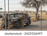 Small photo of Texas National Guard stands guard at the closed gate to Shelby Park, Eagle Pass Tx USA