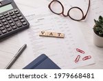 Small photo of Assam, india - March 30, 2021 : Word VAT written on wooden cubes stock image.