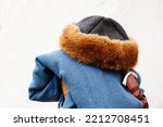Small photo of Fur hat and cloak from the time of chivalry. Warm clothing made from animal skins and woven materials. Light background. Close-up