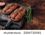 BBQ roasted Shoulder Top Blade cut or Australia wagyu oyster blade beef steak. Dark background. Top View. Copy space
