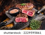 Oyster Top Blade beef meat steak grilled on summer BBQ. Wooden background. Top View.
