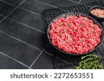 Raw Minced beef and pork meat for a burger patty or meatballs. Black background. Top view. Copy space.