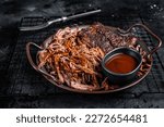 Slow Cooked Pulled Beef, Traditional meat rubbed with spices and smoked in a Texas smoker. Black background. Top view.