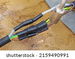 Heat-shrink tubing over underground cables is shrunk with a gas flame