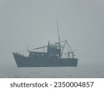 Small photo of Jhargram,India - May15,2023:Capture the essence of maritime life with a fishing boat adrift the endless sea. A silent voyage into the horizon, where the rhythm of the waves meets the toil of the sea
