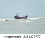 Small photo of Digha,India - June 15,2023:Capture the essence of maritime life with a fishing boat adrift the endless sea. A silent voyage into the horizon, where the rhythm of the waves meets the toil of the sea