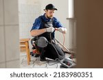 Small photo of Connecting cables with a plug, extension cord plugging in construction equipment, breakdown, short circuit in house during renovation experienced man in field of electricity repairs electrical.