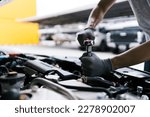 Small photo of Professional car mechanic using a wrench for working on the engine of the car in the garage for car auto repair service and maintenance check concept for the car before leaving.