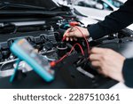 Small photo of Technician Hands of car mechanic working repair in auto repair Service electric battery and Maintenance of car battery. Check the electrical system inside the car.