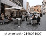 Small photo of ROME APRIL 21 2022 A VIEW OF S.LORENZO IN LUCINA SQUARE IN HISTORICAL CENTER CROWED WITH PEOPLE WITH TABLES OUTSIDE