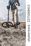 Archaeological and treasure hunting with a metal detector.Hunting for relics in the ground.Search for antiques.Soil research on gold nuggets.A man with a metal detector and a shovel.Finding  research