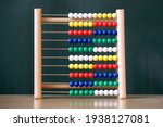 Small photo of Slide rule, abacus with blackboard, elementary school background.