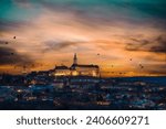 Evening view of the city of Mikulov in blue hour. Mikulov Castle and dramatic clouds at sunset.