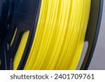Small photo of Yellow filament of plastic for printing on 3D printer. Spools of 3D printing motley thermoplastic filament. ABS, PLA, FDM wire plastic for 3d printer.